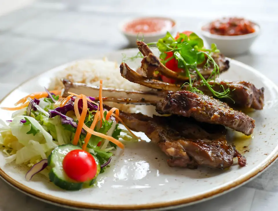 Chargrilled lamb chops with rice, salad and chilli dips